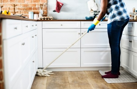 Cleaning Kitchen floor with a mop